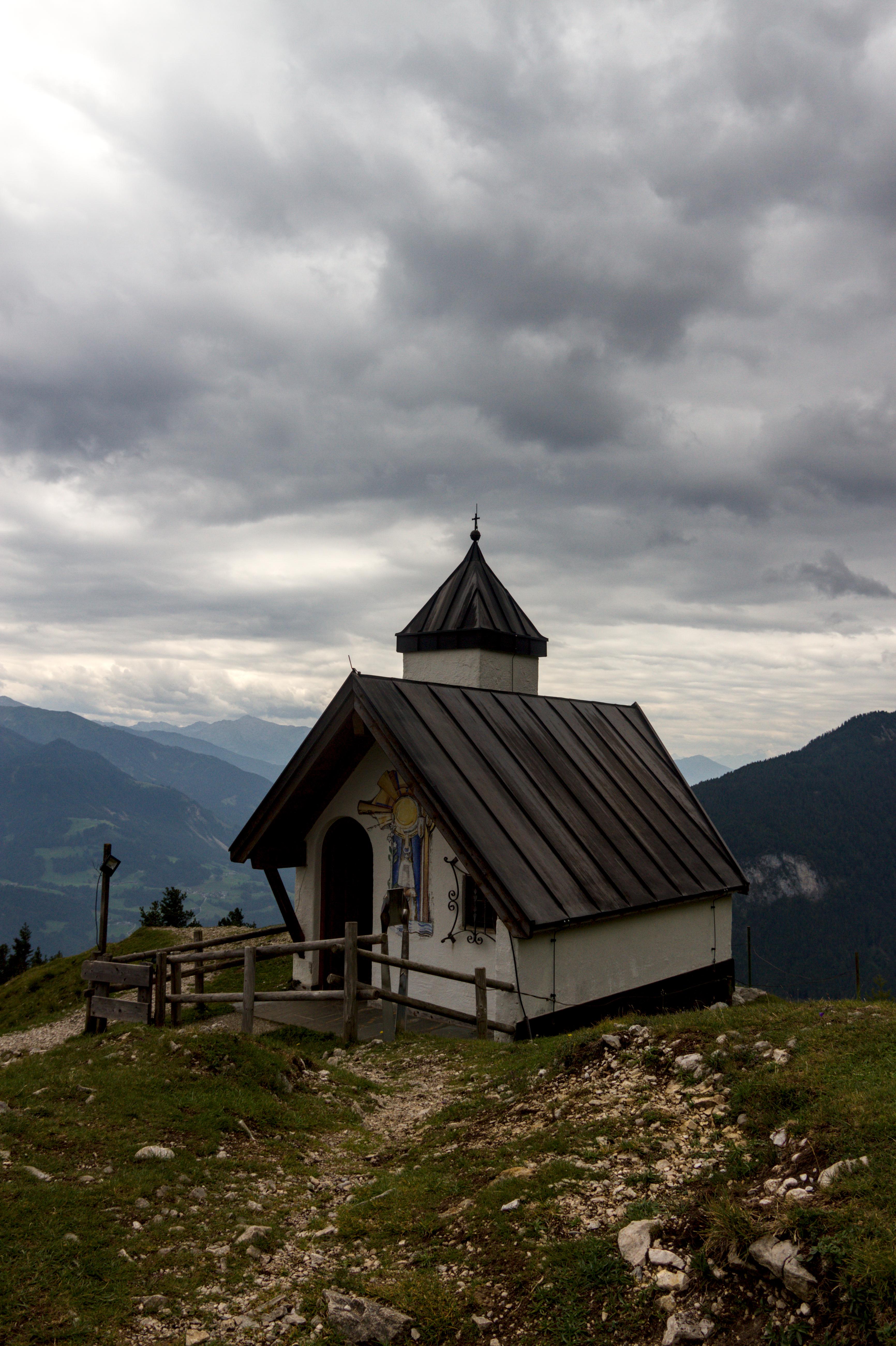 A chapel situated on a hill, overlooking a valley