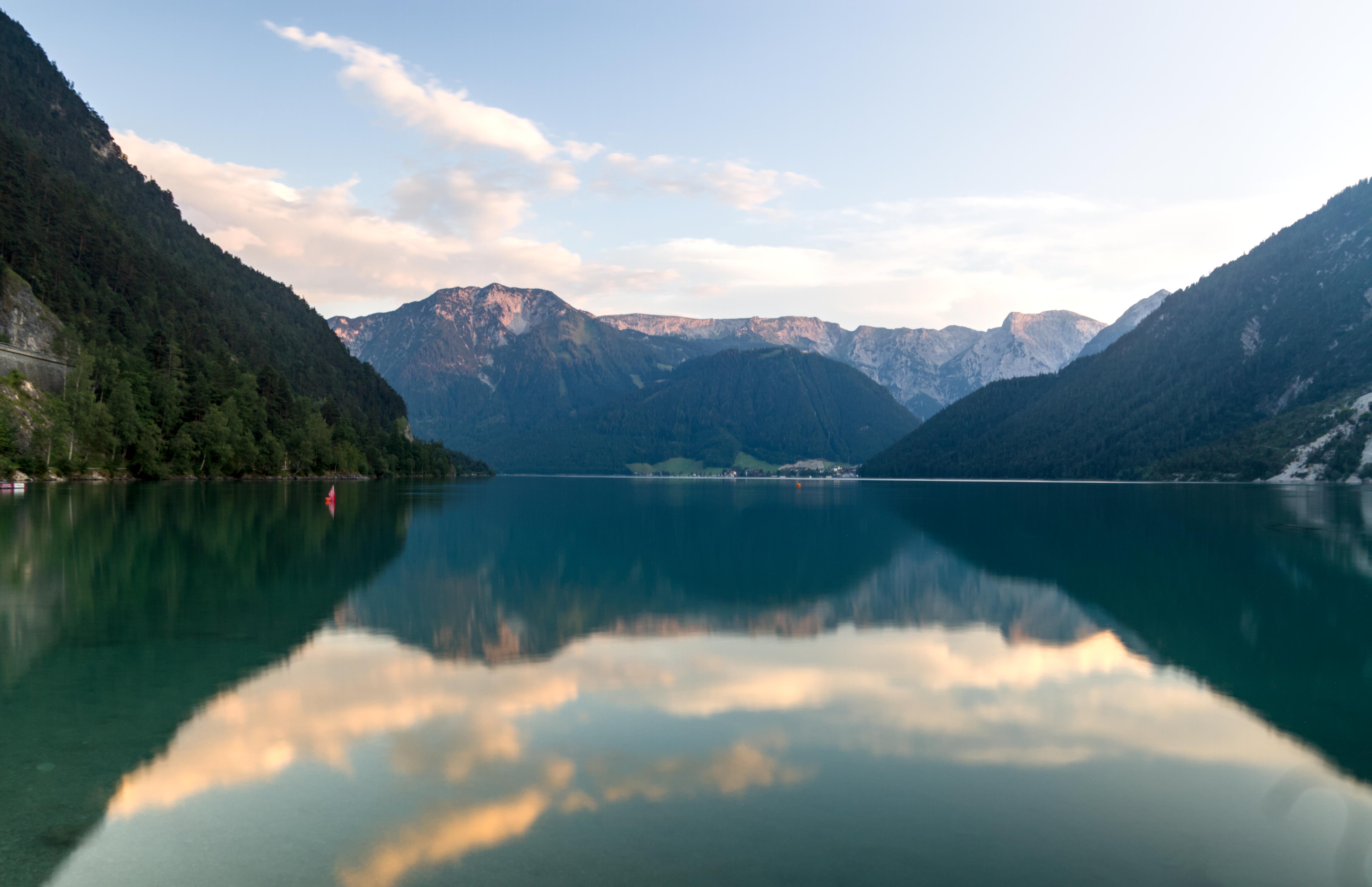 A series of mountains reflecting in the water